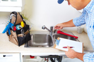 plumber-working-kitchen-sink