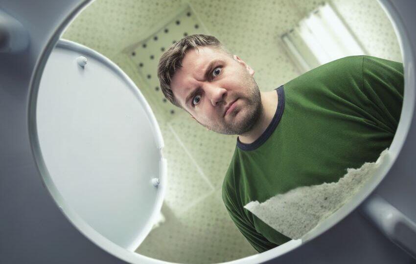 man-looking-inside-toilet